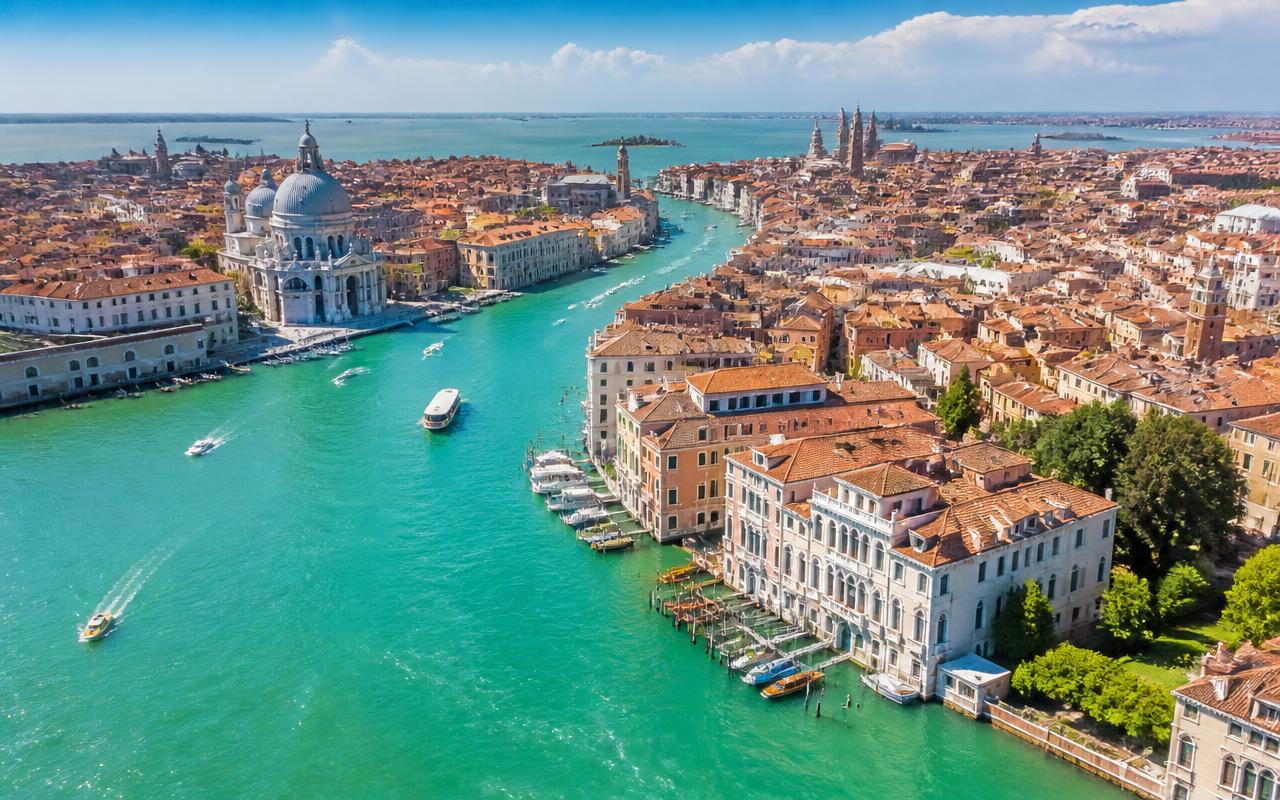 Aerial view of the Grand Canal in Venice with historic palazzos, domes and the lagoon